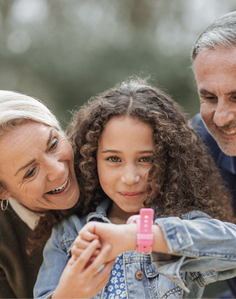 Girl using an Xplora smartwatch with grandparents