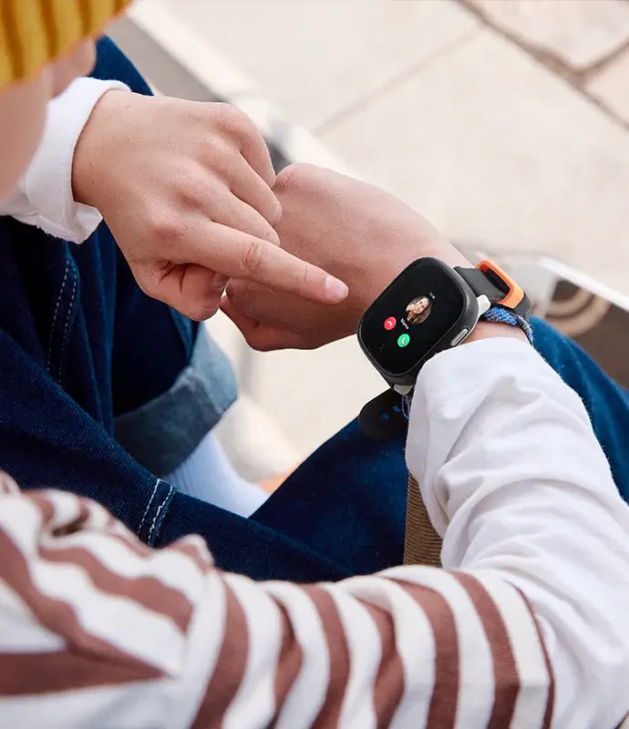 A boy with a X6Play smartwatch for kids with an incoming call from mom.